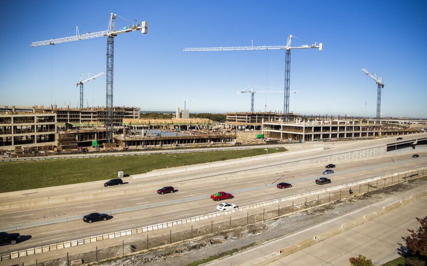 Construction crews work on Plano's Legacy West mixed-use development at the northwest corner...