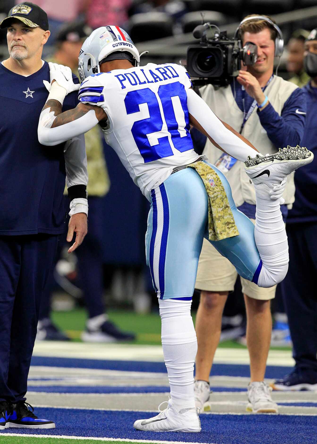 Dallas Cowboys running back Tony Pollard (20) stretches during pre-game workouts before the...