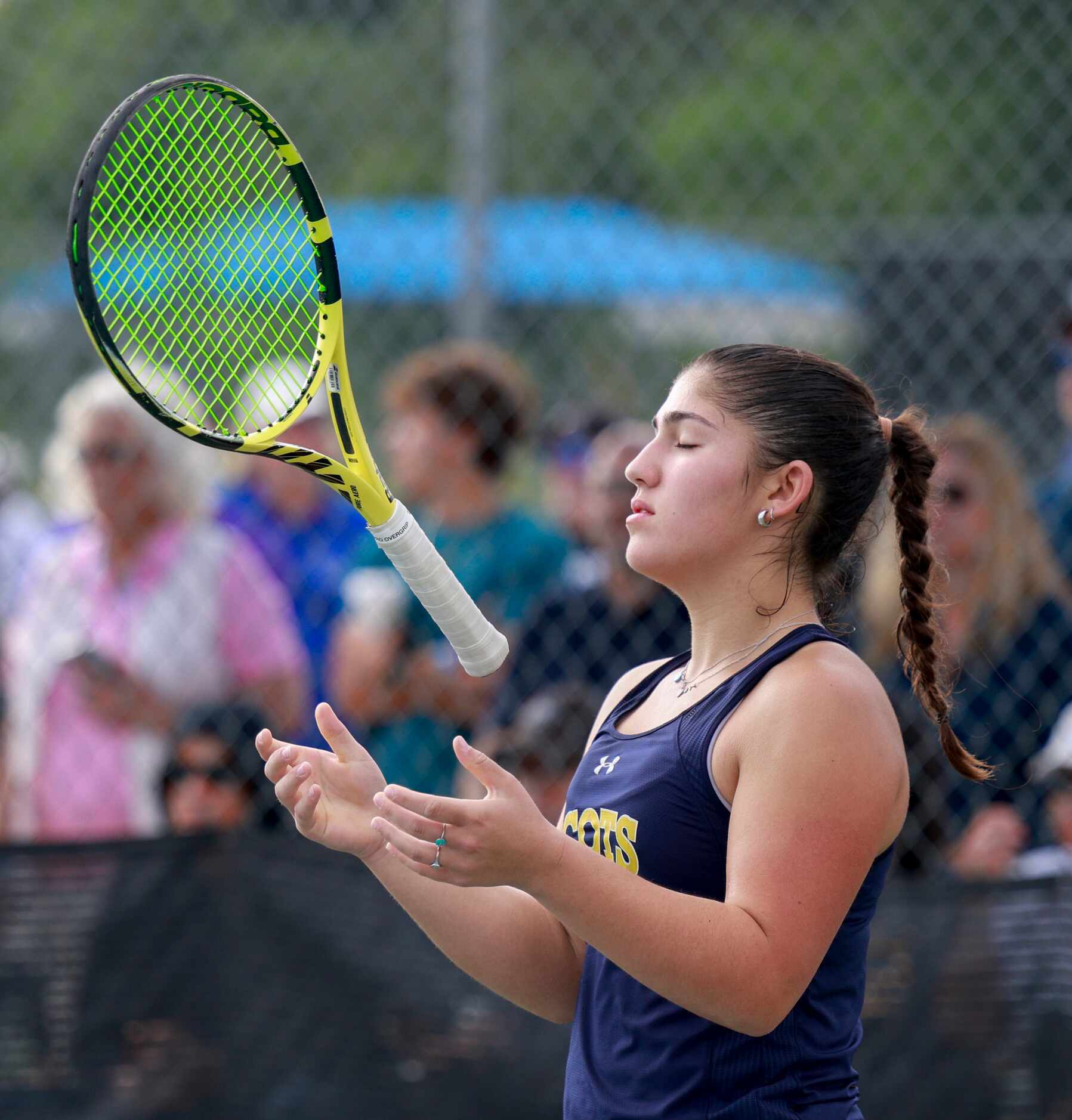 Highland Park’s Eden Rogozinski lightly tosses her racket during the 5A girls doubles...