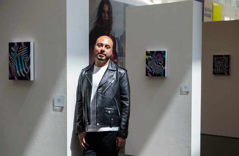 Artist Arthur Peña  alongside his artwork at NorthPark Center 
