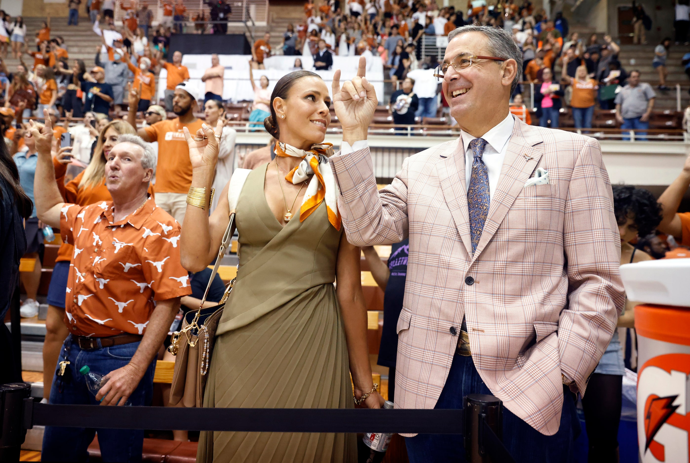 University of Texas Athletic Director Chris Del Conte (right) steps to the court side for...