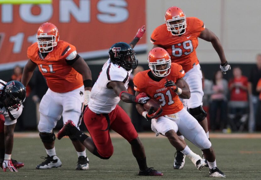 Nov 17, 2012; Stillwater OK, USA; Oklahoma State Cowboys running back Jeremy Smith (31) runs...