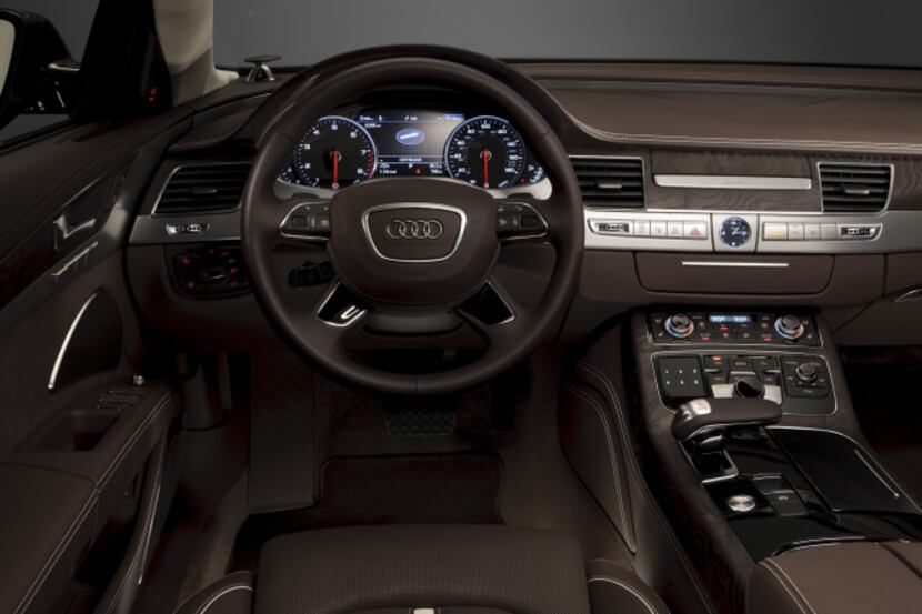 The 2014 Audi A8L TDI’s audio/navigation screen rises from the center of the dash when the...