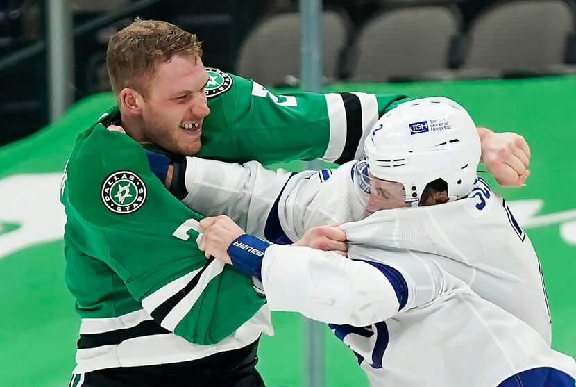 Dallas Stars defenseman Jamie Oleksiak (left) fights with Tampa Bay Lightning defenseman...