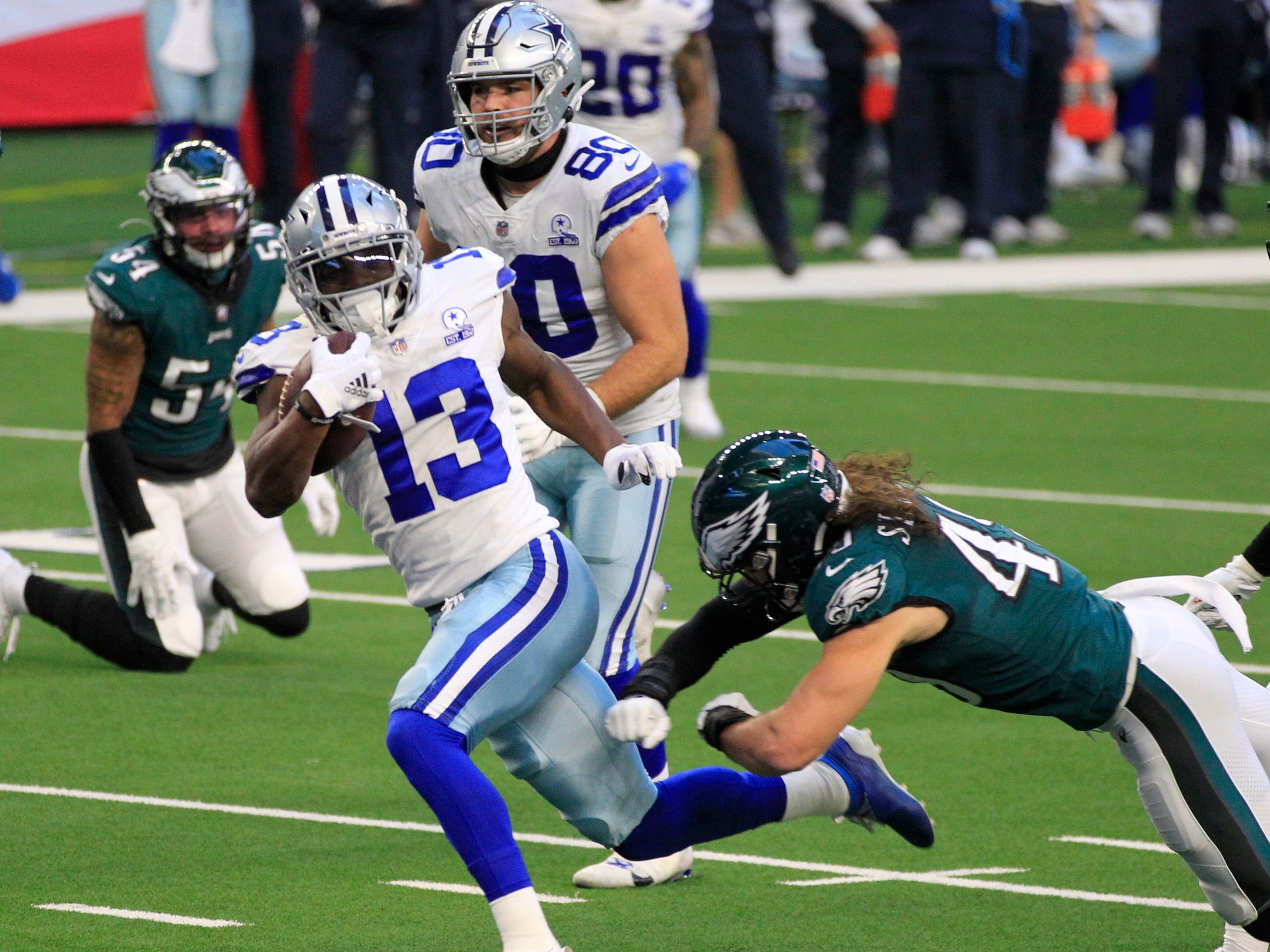 Dallas Cowboys wide receiver Michael Gallup (13) picks his way into the end zone for a...