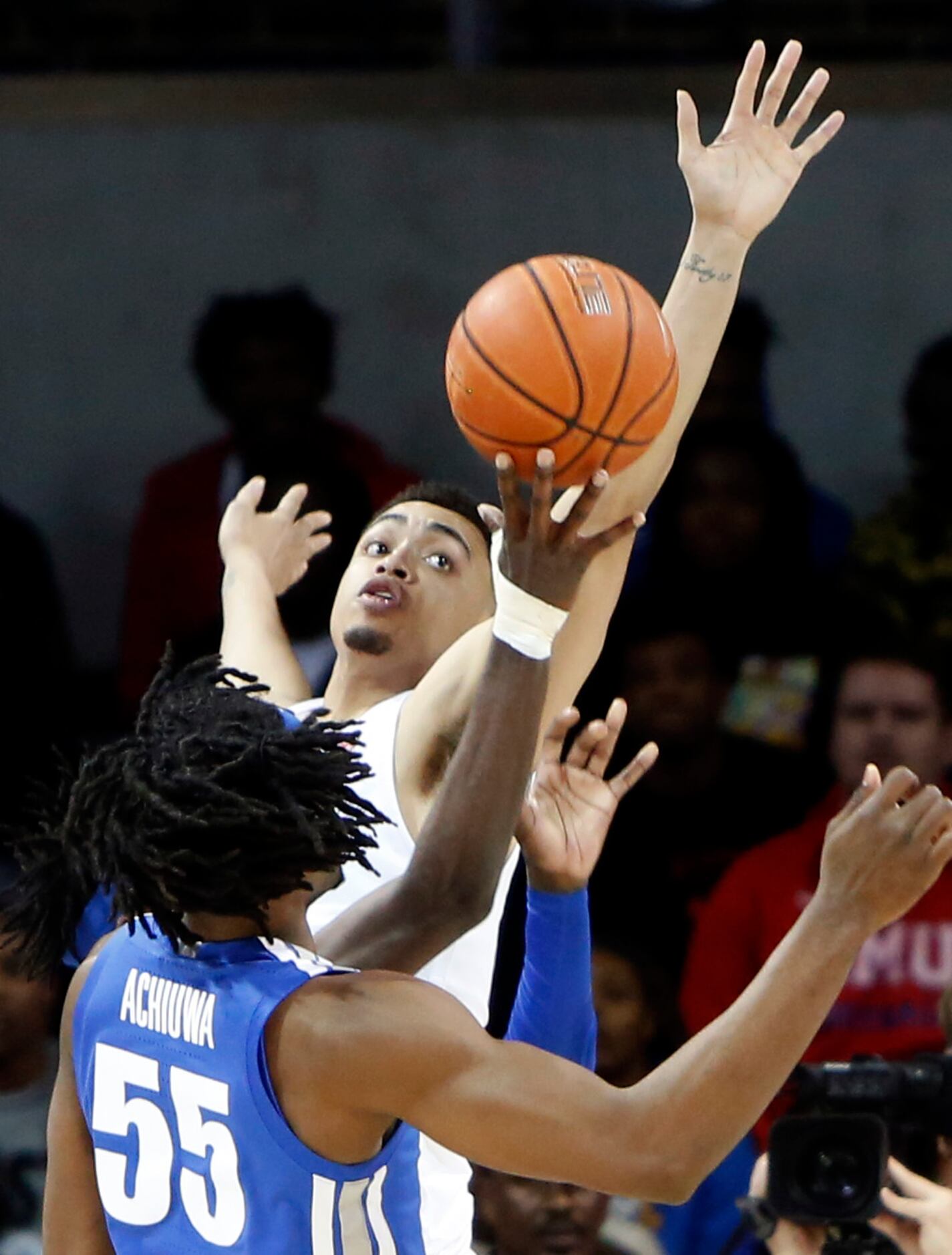 SMU forward Ethan Chargois (25) skies to defend against a shot by Memphis guard Damion Baugh...