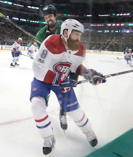 Montreal Canadiens defenseman Jordie Benn (8) is hit by Dallas Stars left wing Jamie Benn...