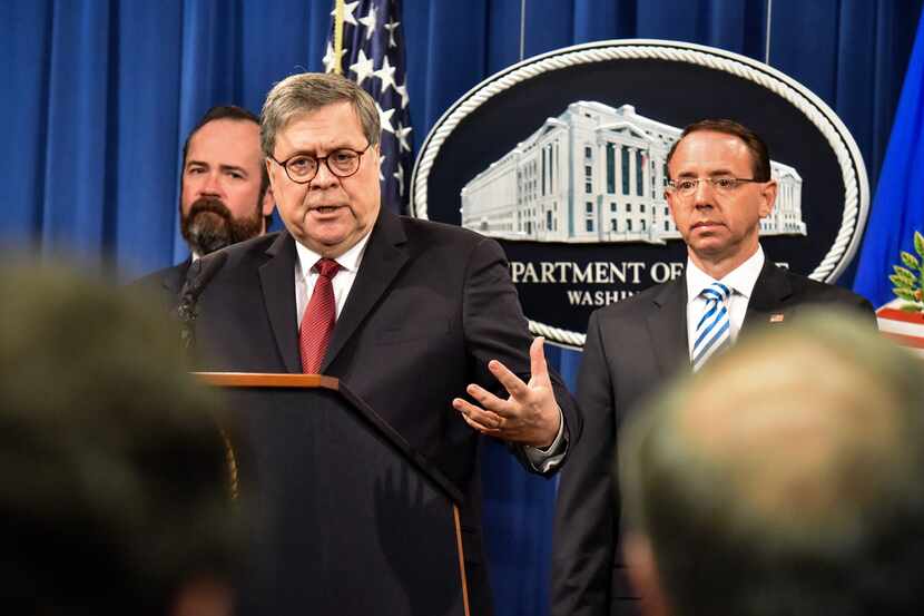 Attorney General William Barr, center, answers a question during a press conference hours...