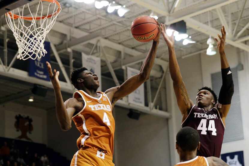 FILE - In this Oct. 25, 2017, file photo, Texas forward Mohamed Bamba (4) grabs a rebound...