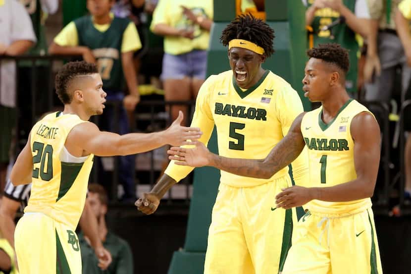 Baylor's Manu Lecomte (20), Wendell Mitchell (1) and Johnathan Motley (5) celebrate in the...