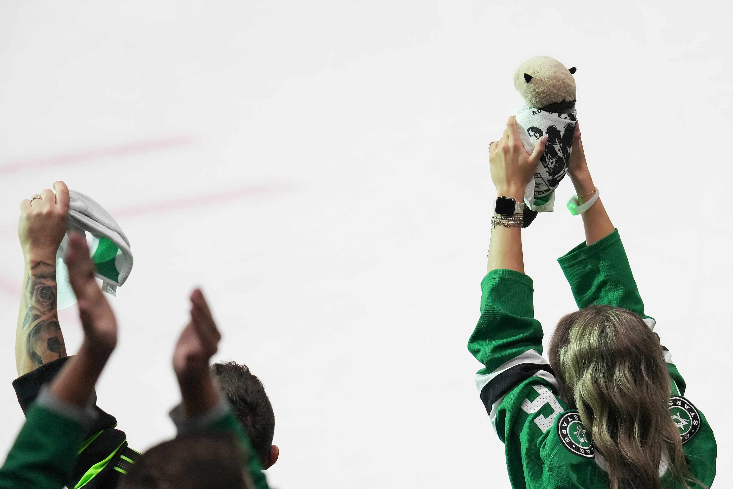 A fan holds up a stuffed otter toy in celebration of a save by Dallas Stars goaltender Jake...