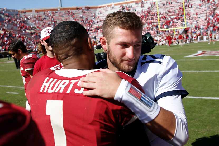 West Virginia quarterback Austin Kendall (12) and Oklahoma quarterback Jalen Hurts (1)...