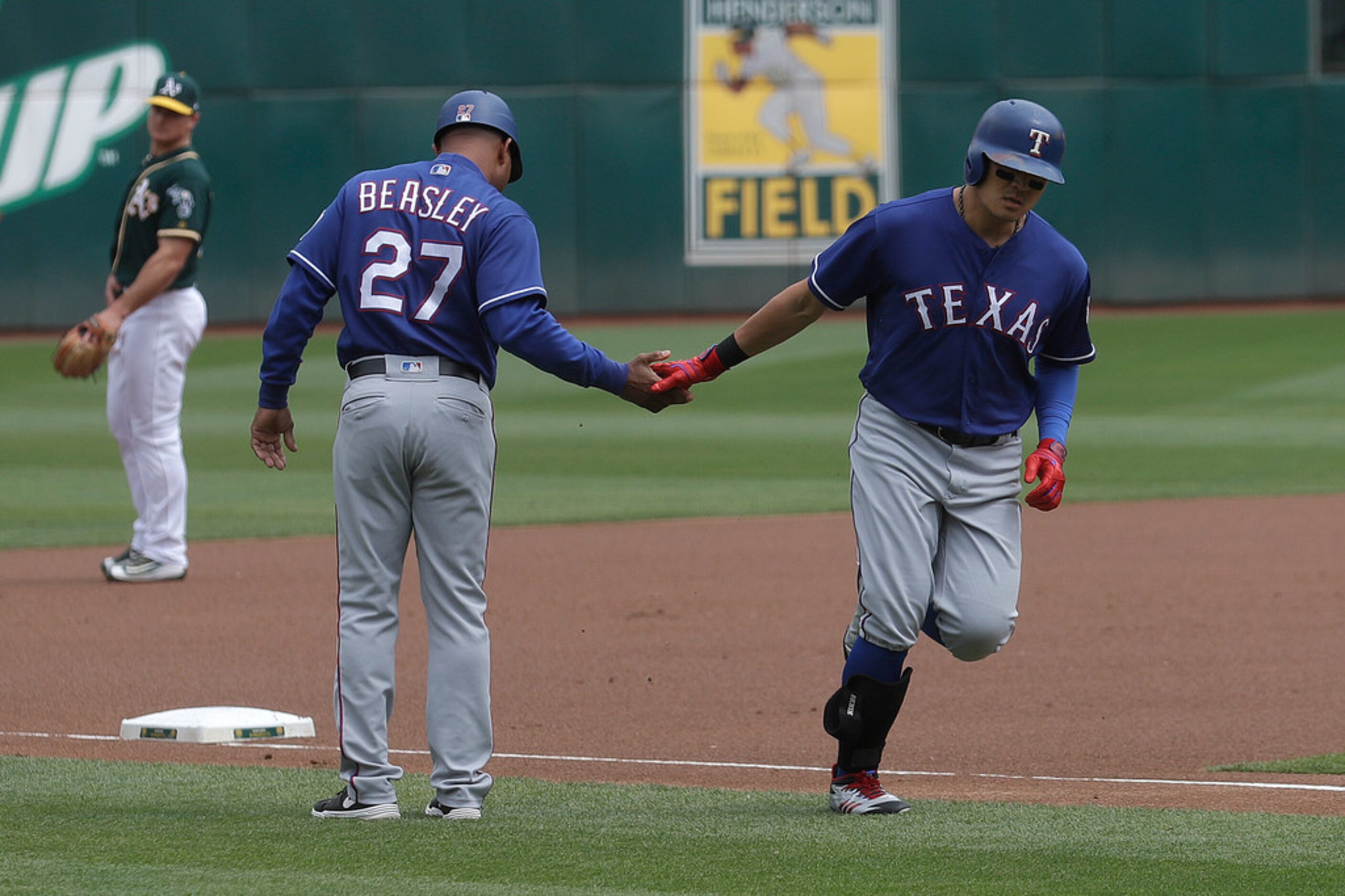 Texas Rangers' Shin-Soo Choo, right, is congratulated by third base coach Tony Beasley (27)...