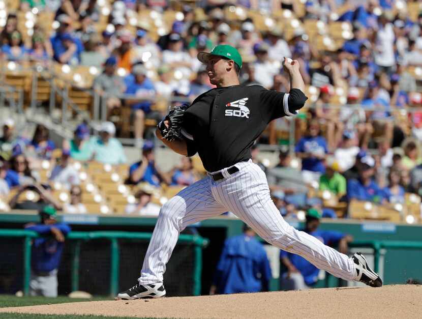 Chicago White Sox's Derek Holland throws during the first inning of a spring training...