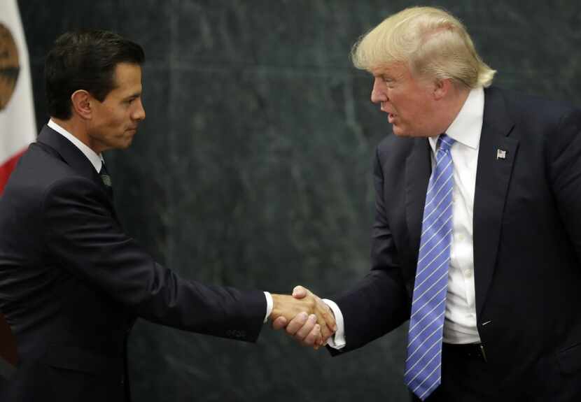 Mexican President Enrique Pena Nieto and U.S. president-elect Donald Trump shook hands after...