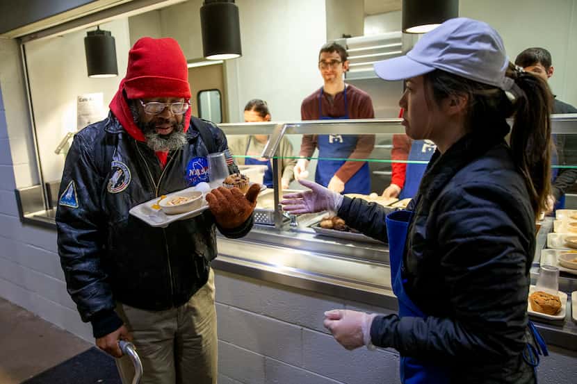 Nghiem Duong helped Randy as he carefully balanced his breakfast tray at The Bridge Homeless...