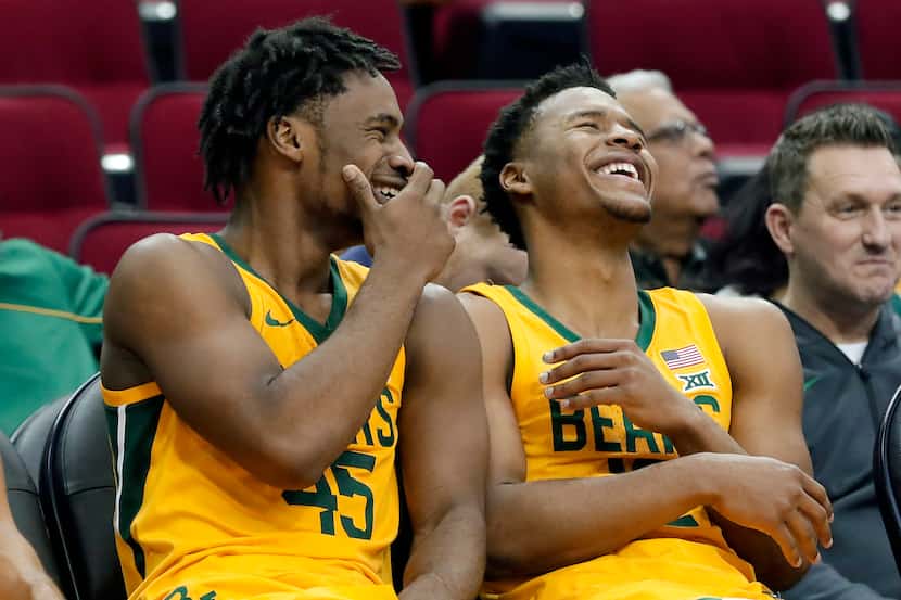 Baylor guard Davion Mitchell (45) and guard Jared Butler (12) laugh on the bench in the...