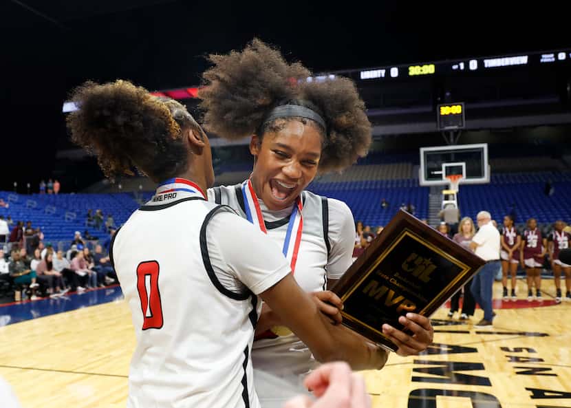 Frisco Liberty's Jacy Abii (3) is hugged by teammate Aziyah Farrier (0) after being named...