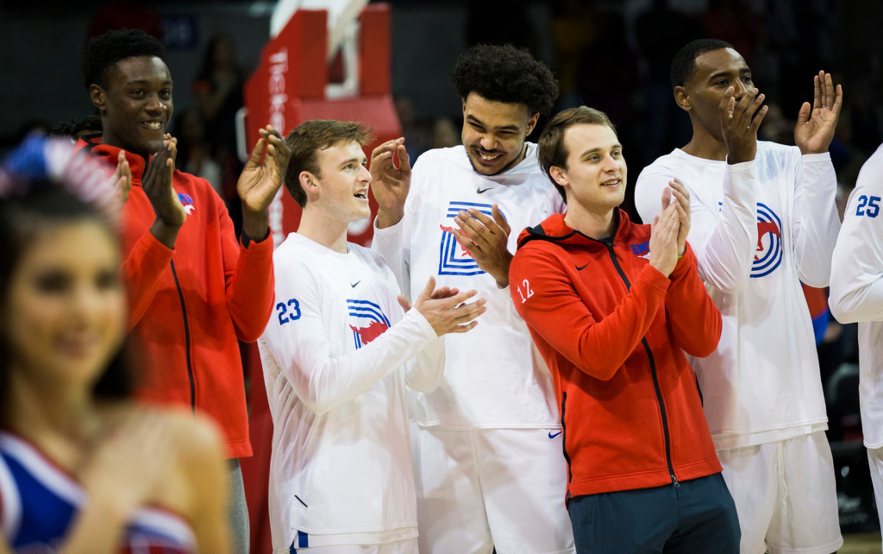 Southern Methodist Mustangs applaud after Lila Tran sang the national anthem before a...