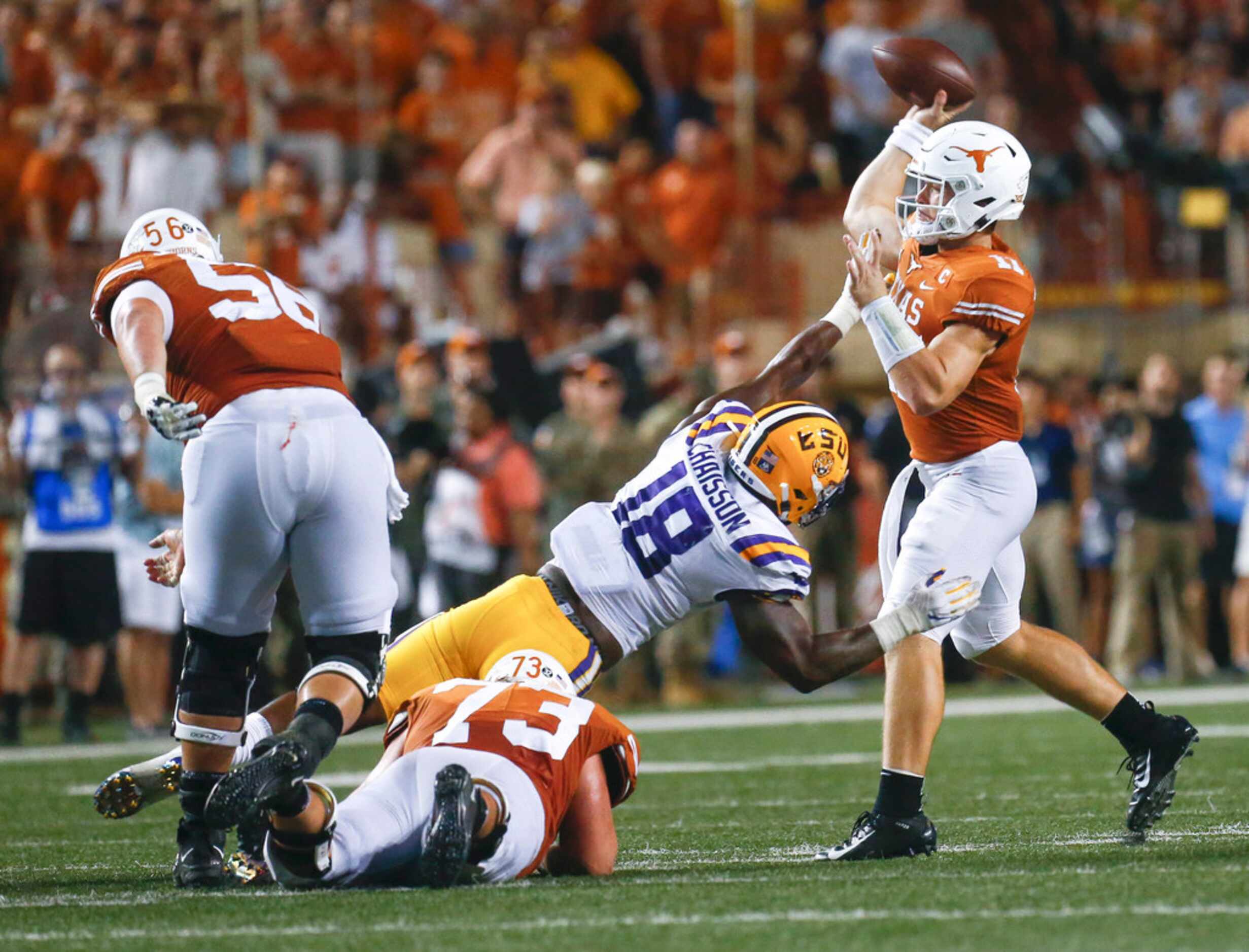Texas Longhorns quarterback Sam Ehlinger (11) fires off a pass over an attempted block by...