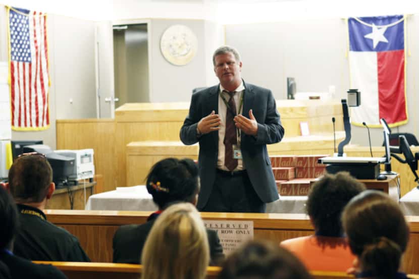 David Bunger of the Dallas County district attorney's office gives a lecture on checks and...