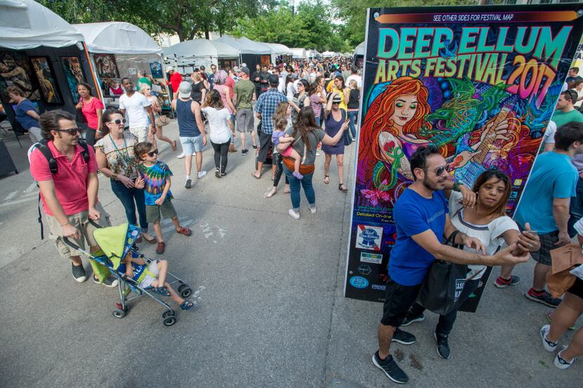 A couple takes a selfie at the Deep Ellum Arts Festival on Main Street in Dallas, Texas on...