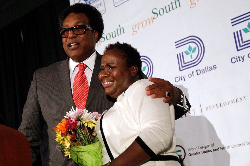 Dwaine Caraway presented a bouquet of flowers to Carolyn Davis at the new Lancaster Urban...