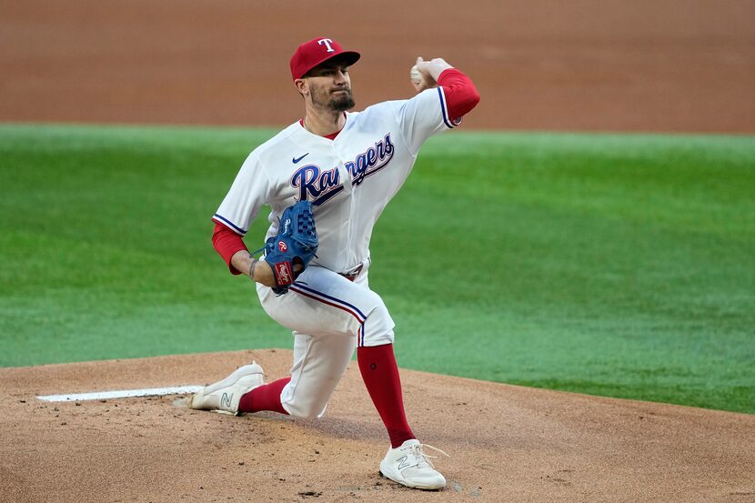 Texas Rangers starting pitcher Andrew Heaney throws to the Kansas City Royals in the first...