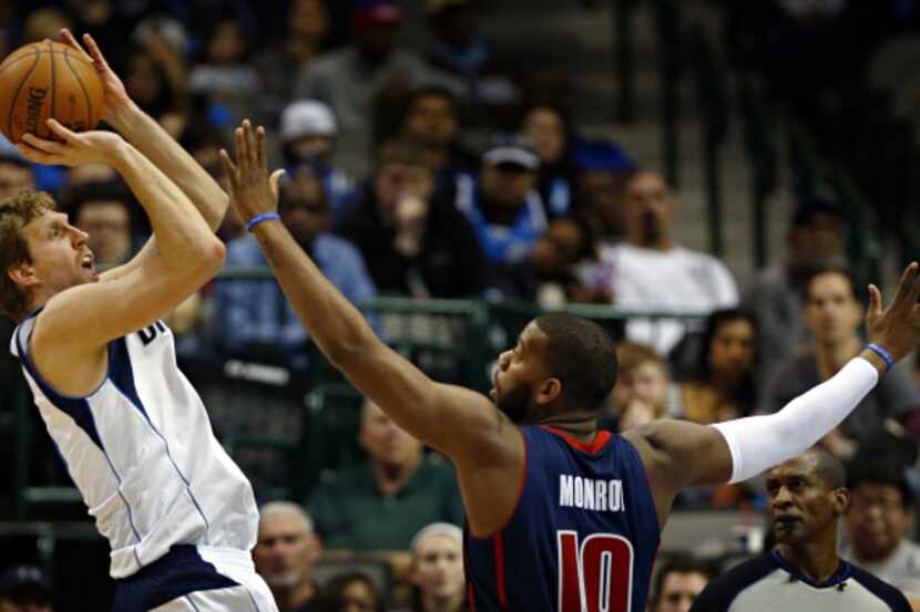 Dallas Mavericks power forward Dirk Nowitzki (left) goes up against Detroit Pistons power...