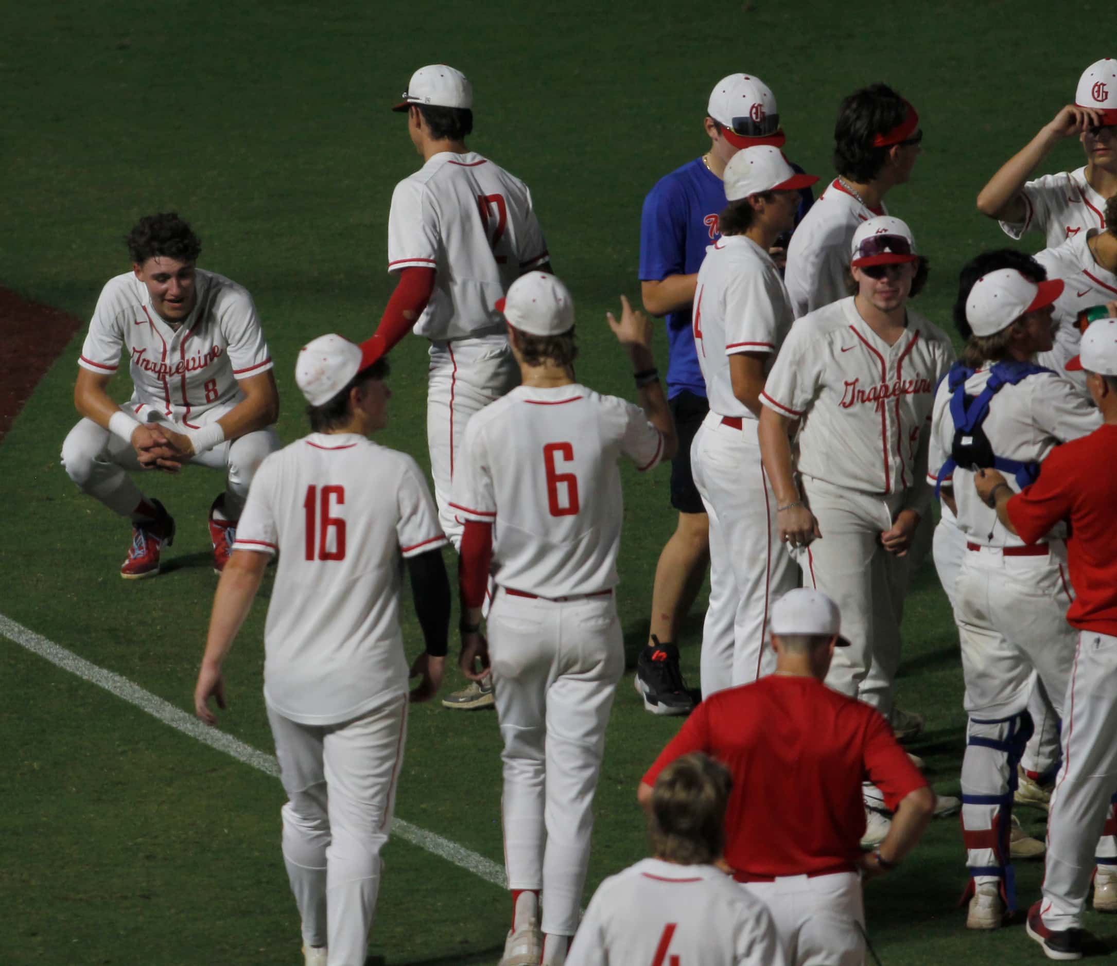 Grapevine outfielder Brady Boozer (8), upper left, pauses to take in the moment following...