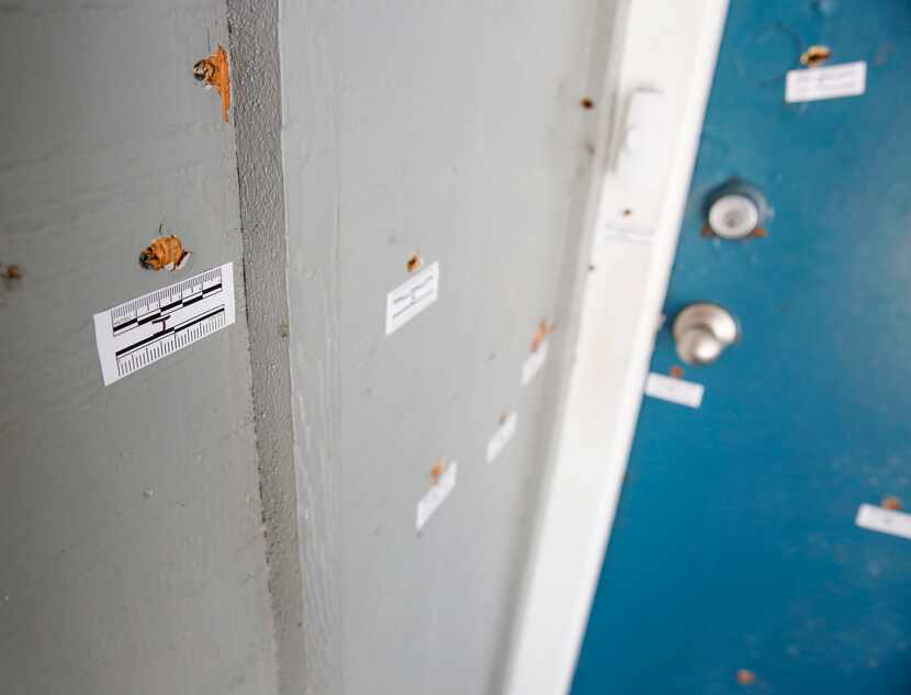 Several bullet holes are visible in and around the door of an apartment at La Bella Palms...