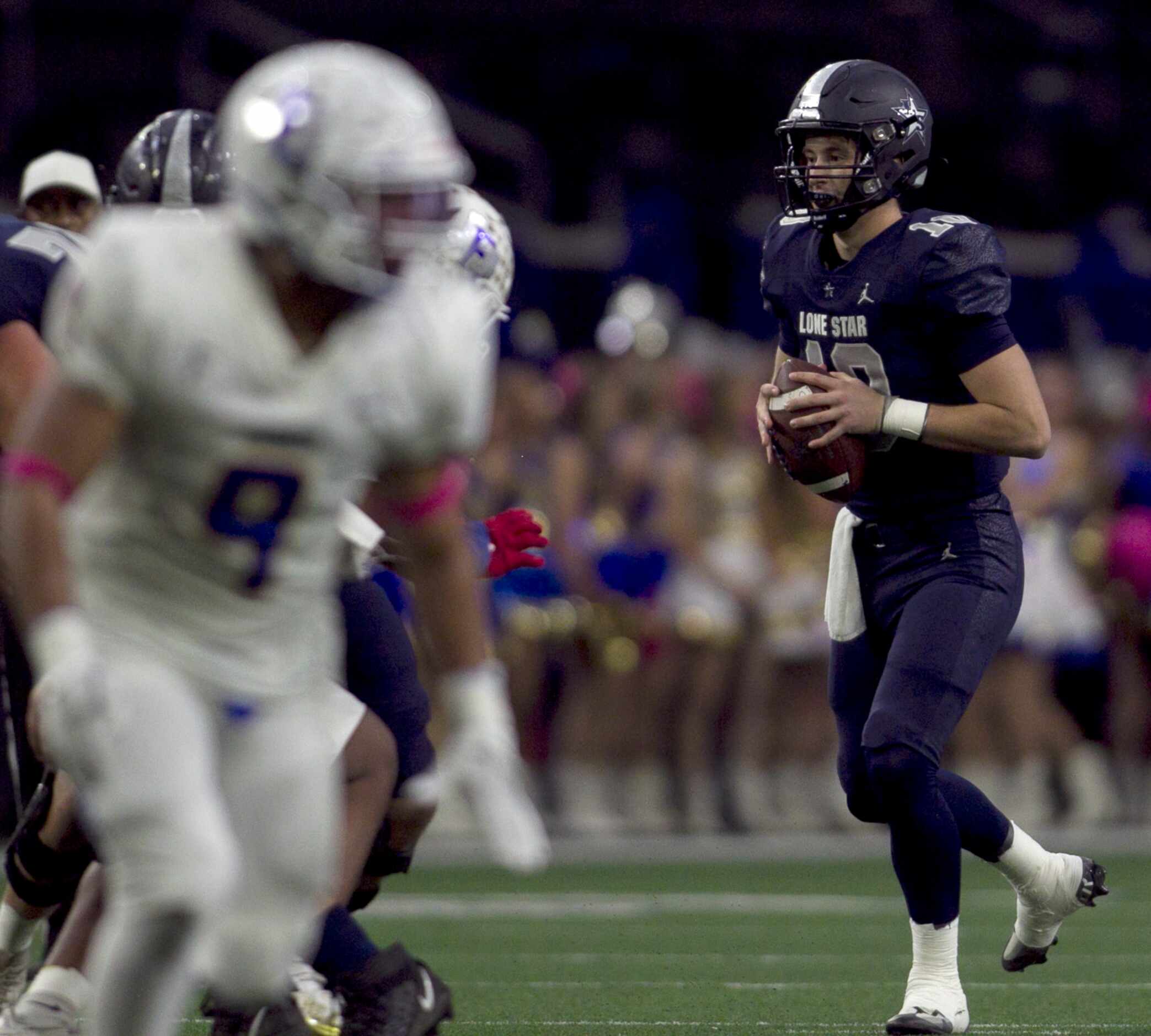 Frisco Lone Star quarterback Collin Blackstock (10) looks for a receiver before rushing for...
