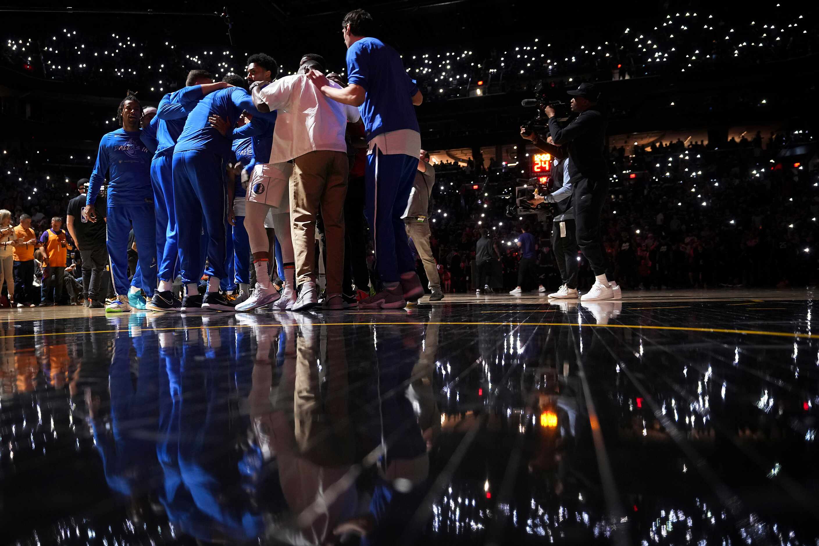 Dallas Mavericks players huddle on the court before Game 1 of an NBA second round playoff...
