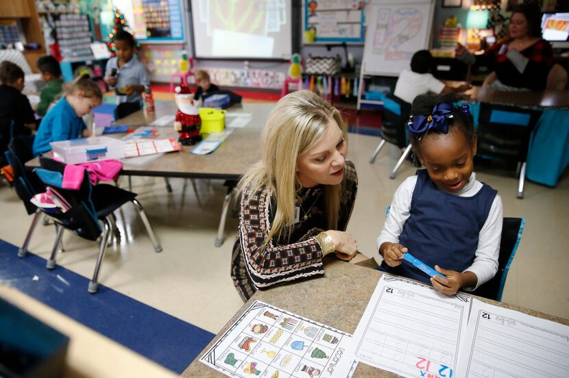 Kindergartner Alexandria Zachery talks about the number 12 with principal Aimee Lewis at...