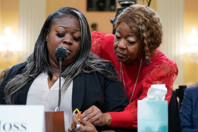 Wandrea "Shaye" Moss, a former Georgia election worker, is comforted by her mother, Ruby...