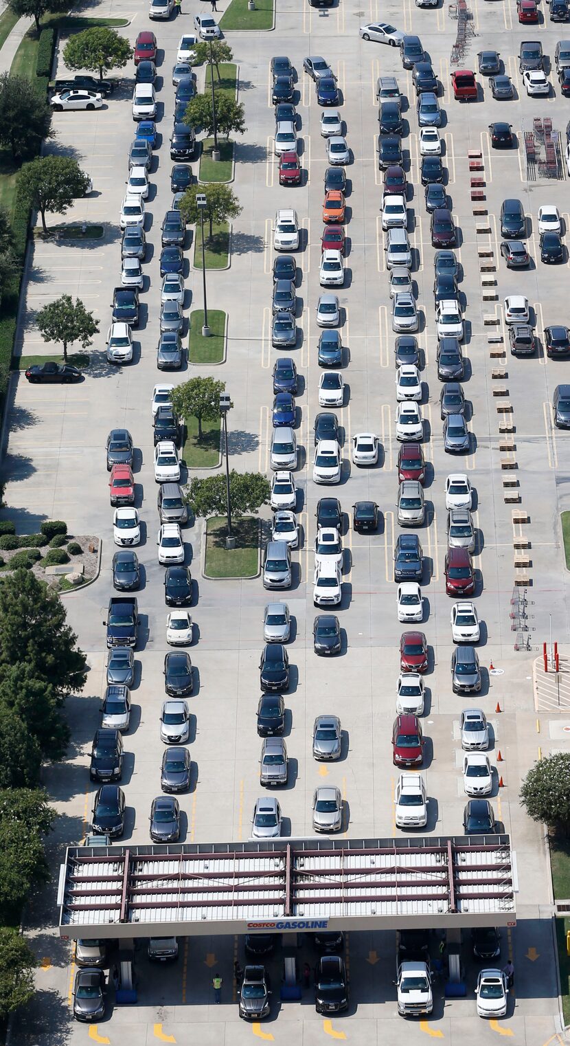 People wait in line to get gas at the Costco at Sam Rayburn Tollway and I-35 in Lewisville,...