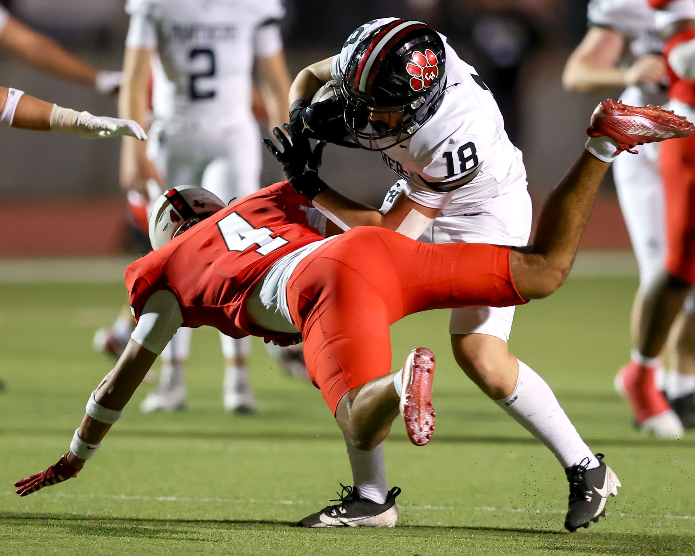 Colleyville Heritage wide receiver Blake Wendler (18) gets tangled up with Argyle defensive...