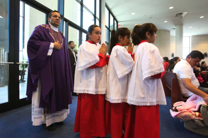 The Rev. Wilmer Daza prepares for a processional into Mass at Nuestra Señora del Pilar...