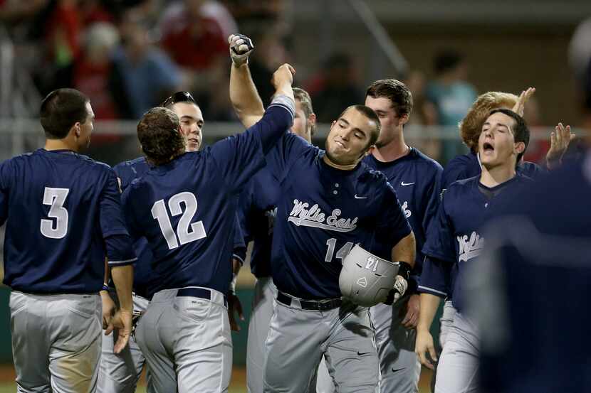 Wylie East Raiders first baseman Mitchell Clark (14) is met by teammates after hitting a...