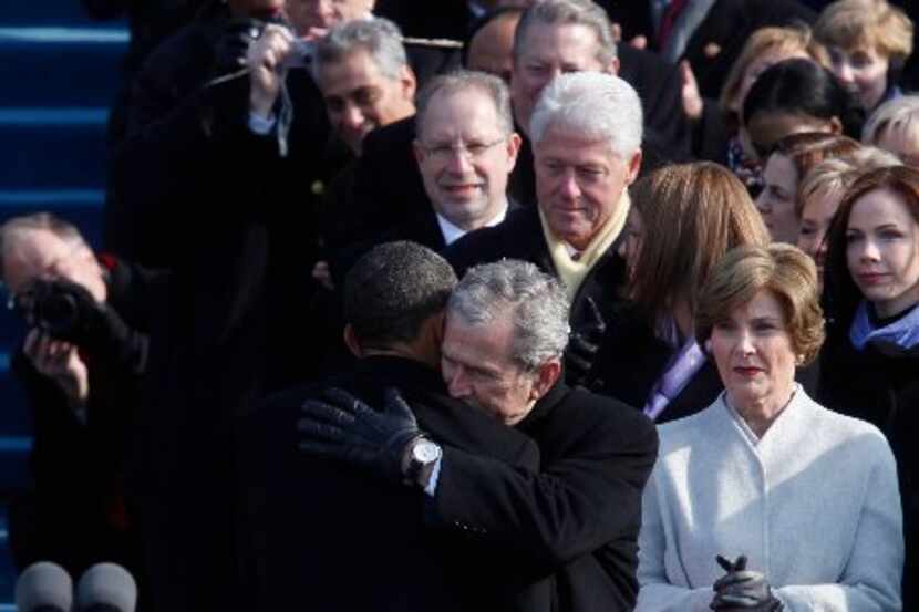 President Barack Obama is embraced by former President George Bush moments after Obama was...
