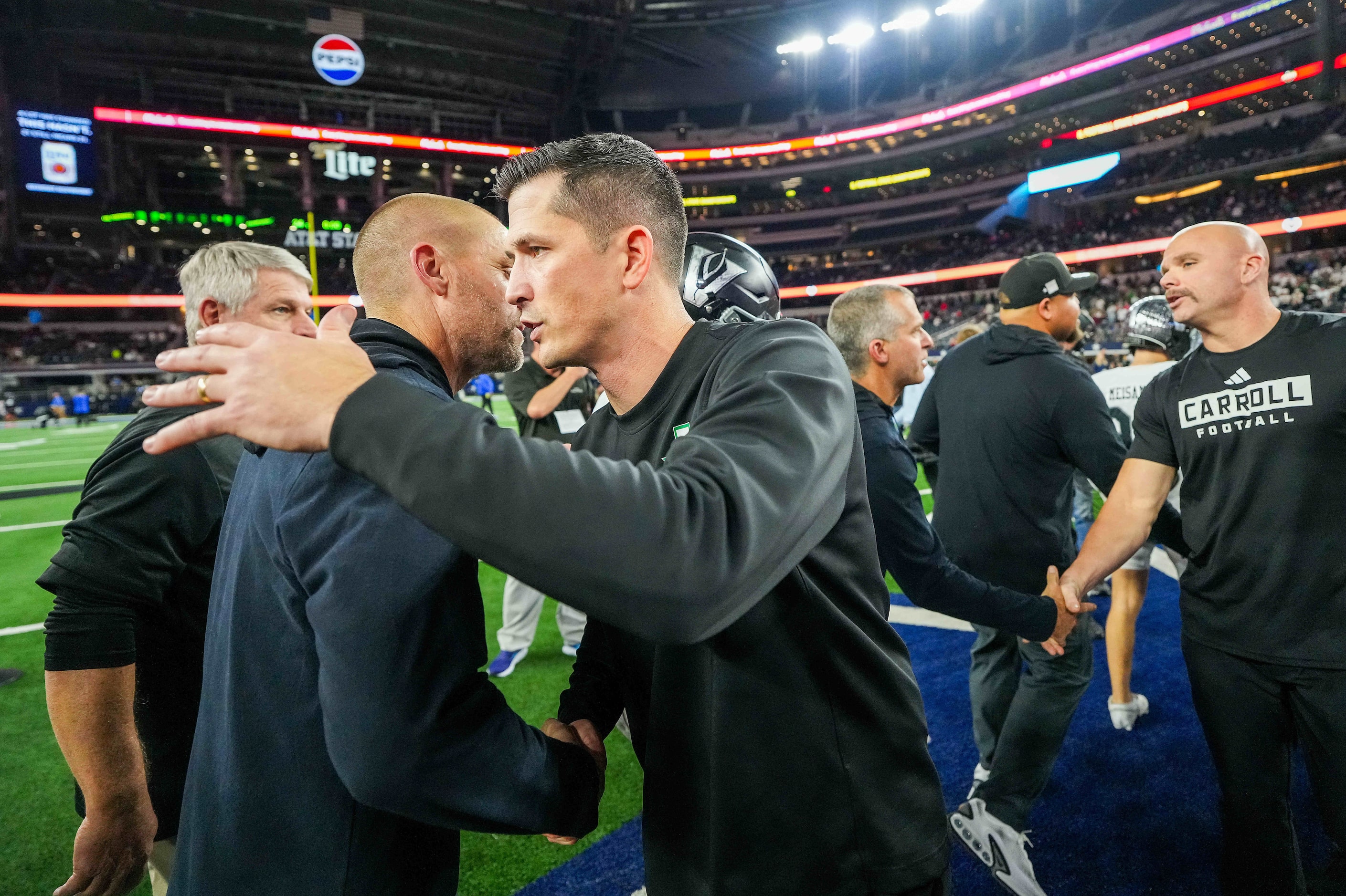 Southlake Carroll head coach Riley Dodge congratulates Austin Vandegrift head coach Drew...