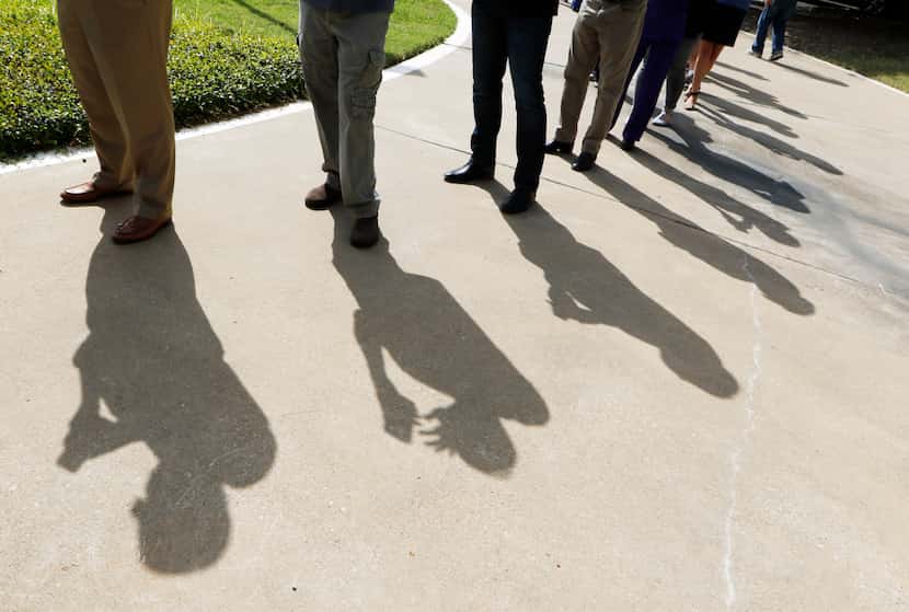 Voters wait in line early at Our Redeemer Lutheran Church in Dallas on Monday, October 24,...