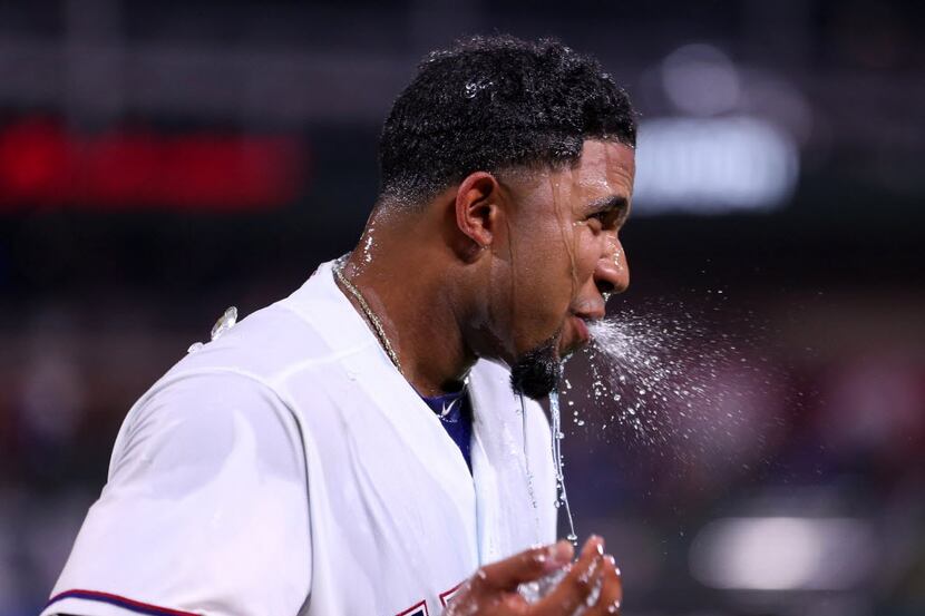 Texas Rangers shortstop Elvis Andrus (1) is dunked with Powerade after a 6-5 win against the...