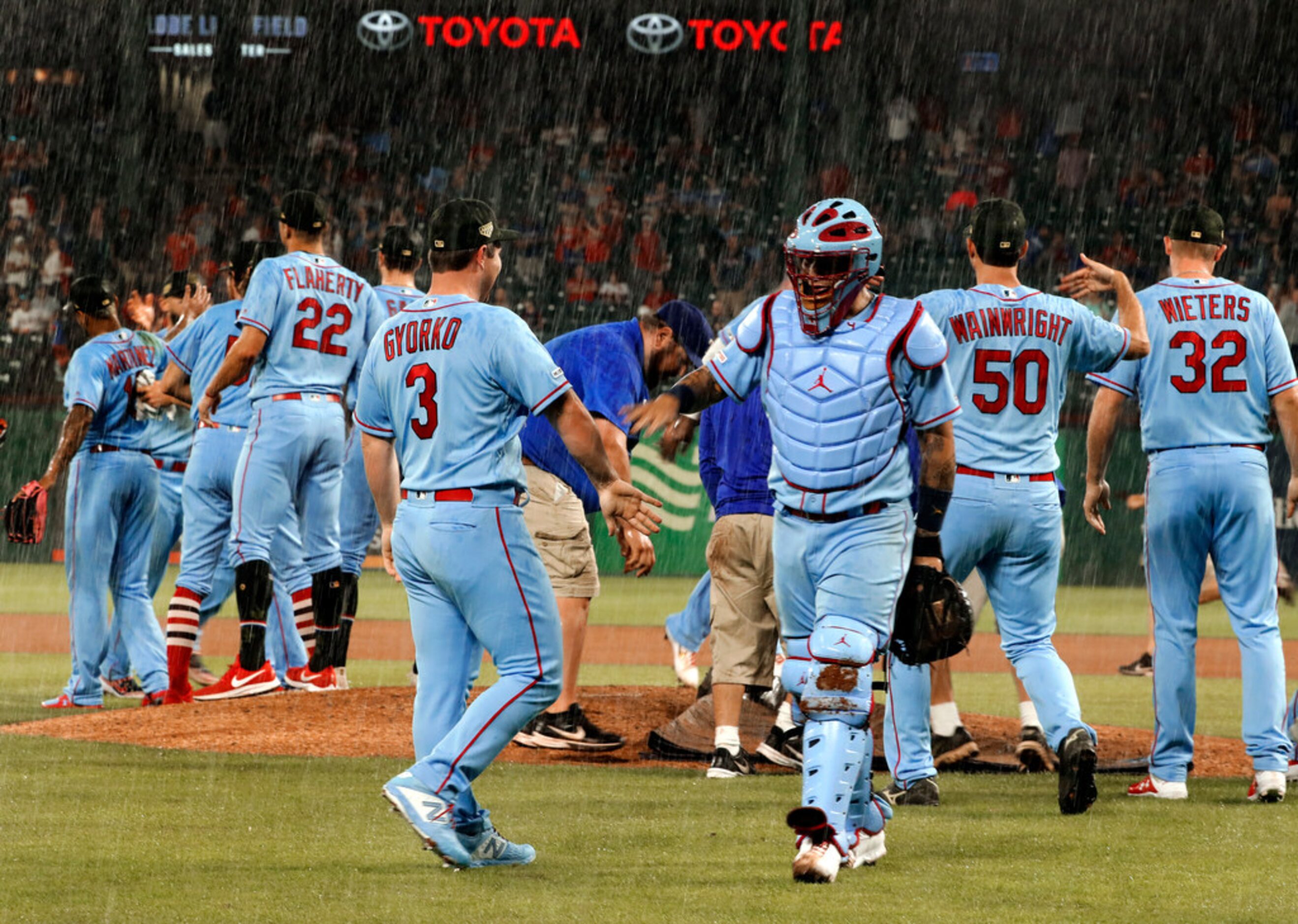 St. Louis Cardinals' Jedd Gyorko (3), catcher Yadier Molina, center right, and the rest of...