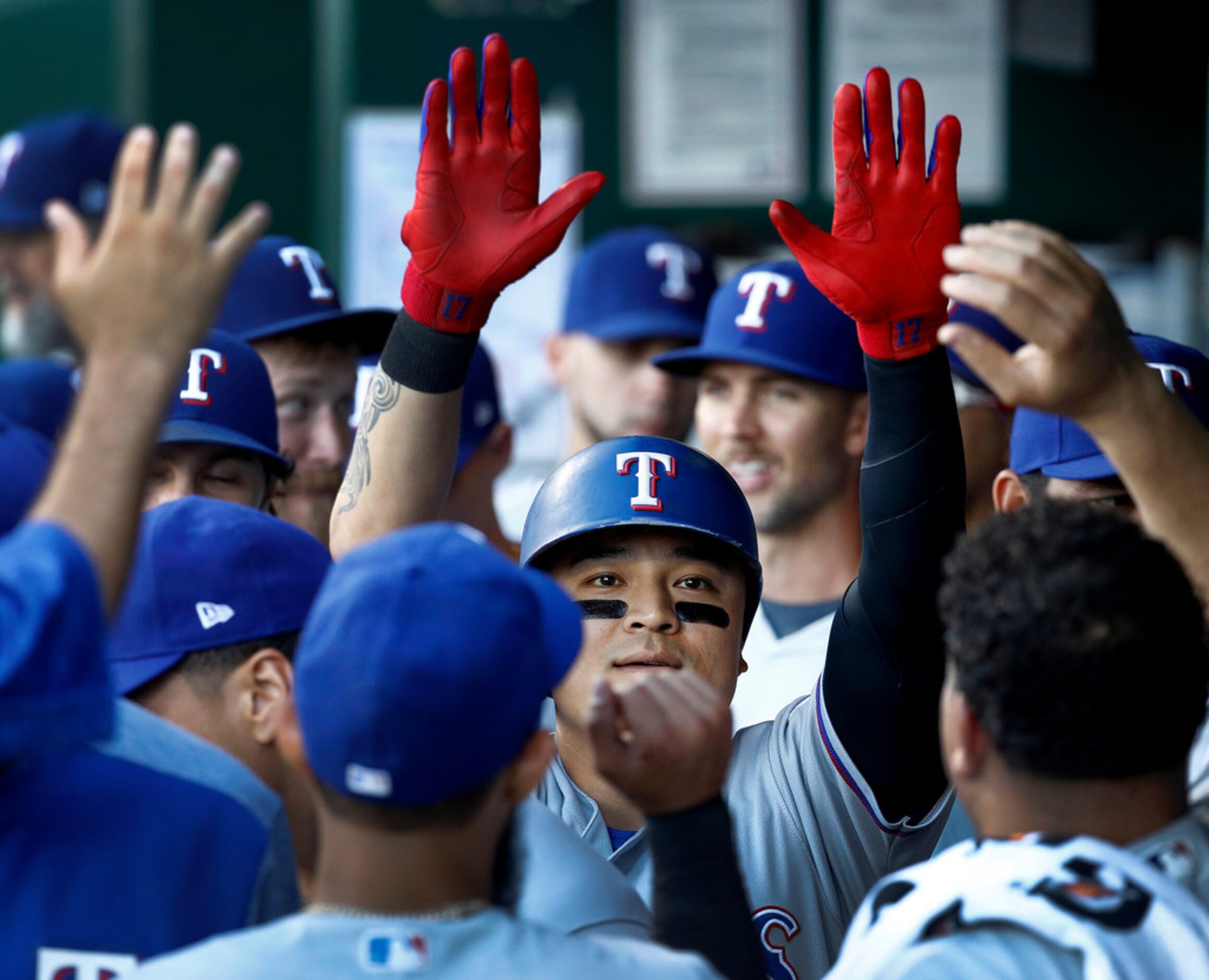 Texas Rangers' Shin-Soo Choo celebrates in the dugout after hitting a solo home run during...