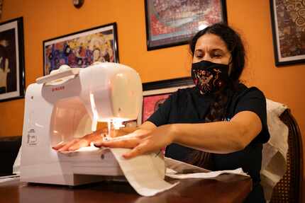 Frida Espinosa-Müller works on a Day of the Dead harness for puppets in Dallas. The puppets...
