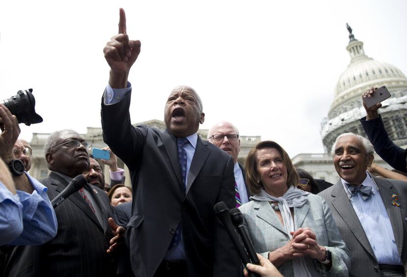 Rep. John Lewis, D-Ga., center, speaks on Capitol Hill in Washington after a sit-in last...