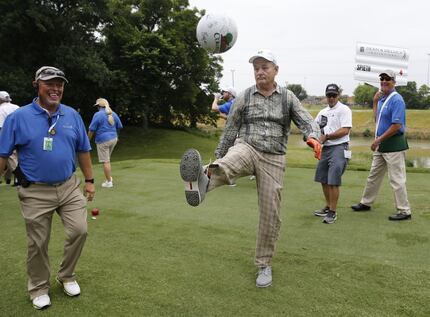 Actor Bill Murray punts a ball a kid gave him to sign in between holes during the Colonial...