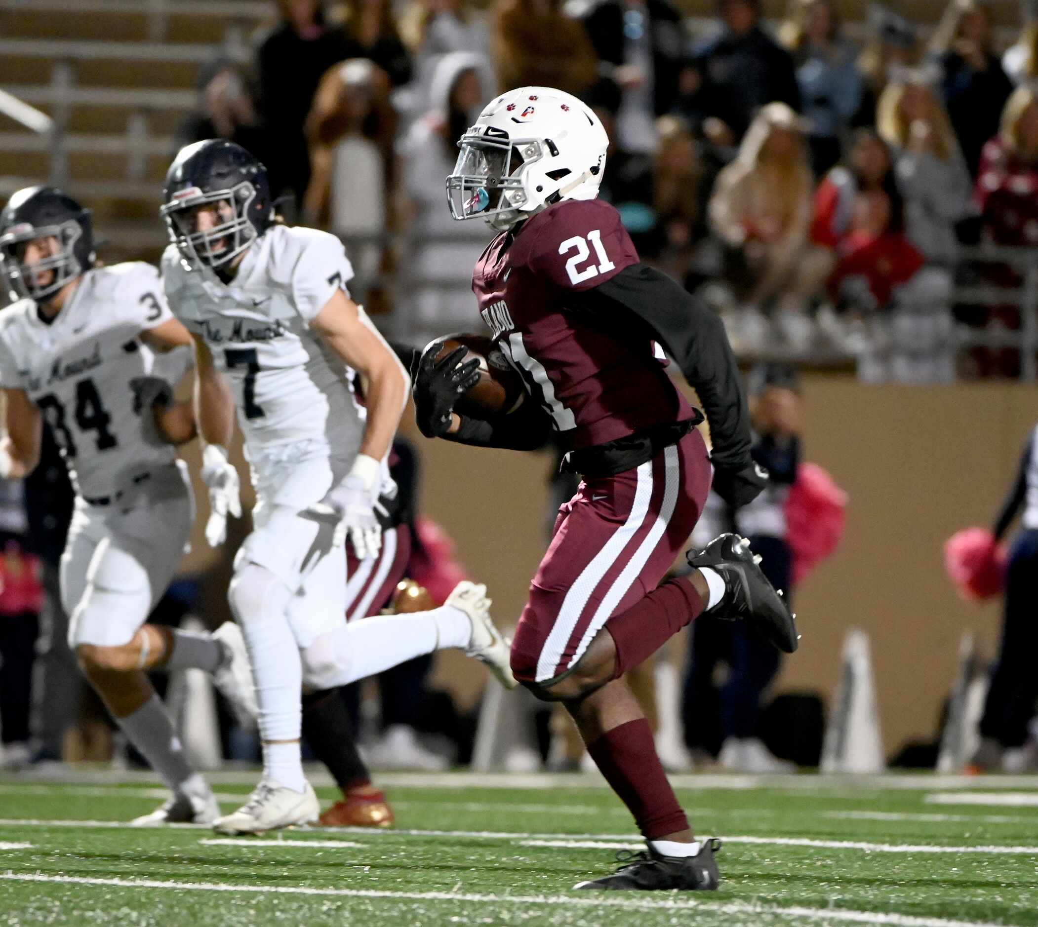 Plano’s Jacob Emmers (21) runs upfield on his way to a long touchdown reception in the first...