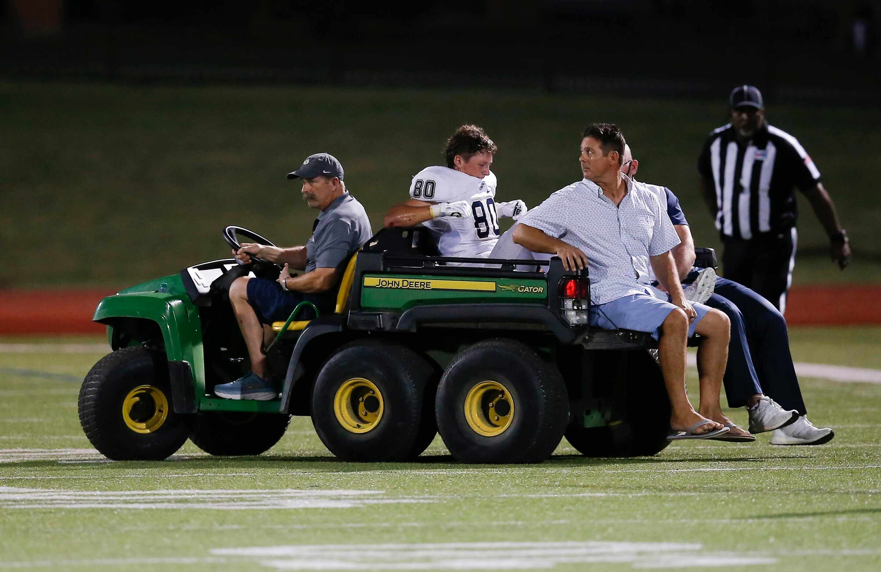 Jesuit junior wide receiver Matty Wagner (80) is carted off the field after taking a hit...
